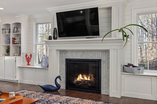 23 Rockrimmon Rd, North Hampton, NH 03862 - detailed view of wood finished floors, a tiled fireplace, and crown molding