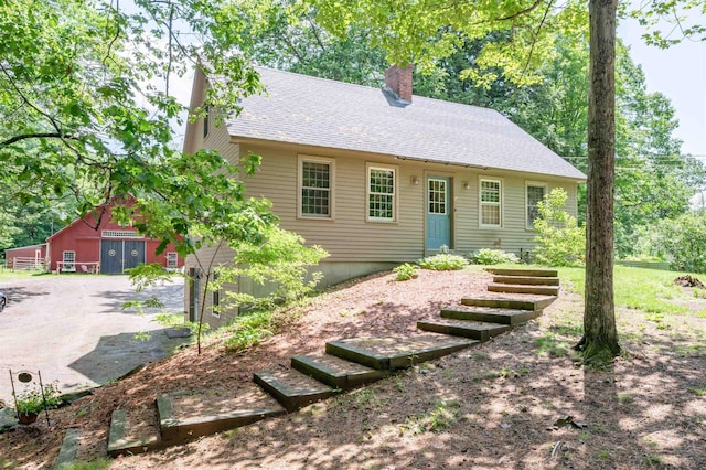 15 Baptist Hill Rd, Canterbury, NH 03224 - view of front of property featuring a chimney, a shingled roof, and an outdoor structure
