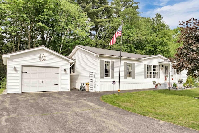638 Benton Dr, Laconia, NH 03246 - view of front of house with an outbuilding, driveway, an attached garage, and a front yard