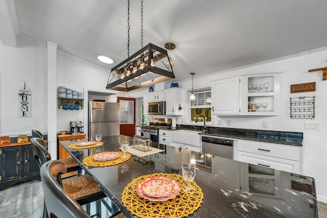 638 Benton Dr, Laconia, NH 03246 - kitchen featuring appliances with stainless steel finishes, open shelves, white cabinetry, a breakfast bar, and wood finished floors