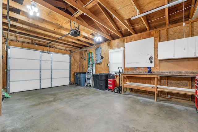 638 Benton Dr, Laconia, NH 03246 - garage with a garage door opener and a workshop area