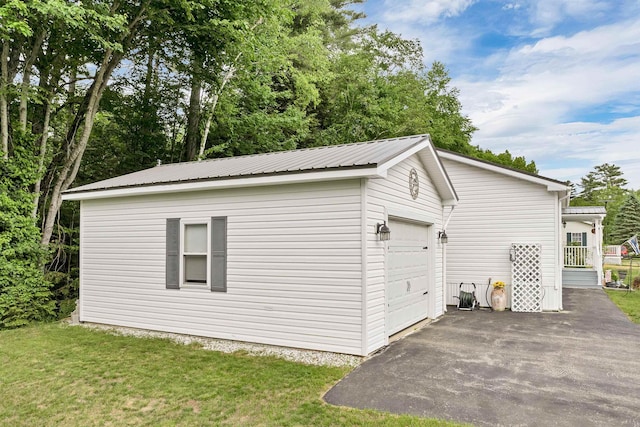 638 Benton Dr, Laconia, NH 03246 - view of side of home with an outdoor structure, a metal roof, a yard, a garage, and asphalt driveway