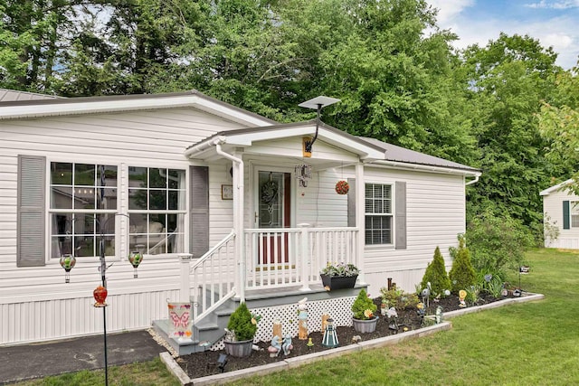 638 Benton Dr, Laconia, NH 03246 - view of front of home with a front lawn and a metal roof