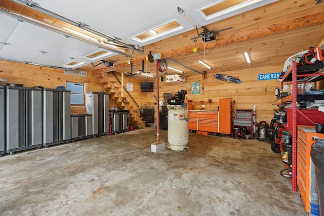 161 Micah Ter, Milton, NH 03851 - garage featuring a garage door opener, a workshop area, and wood walls