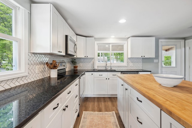 161 Micah Ter, Milton, NH 03851 - kitchen featuring appliances with stainless steel finishes, butcher block countertops, light wood-style flooring, decorative backsplash, and healthy amount of natural light