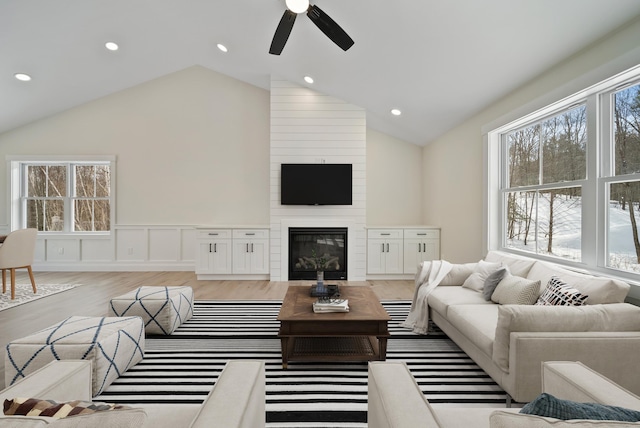 172 Tasker Hill Rd, Strafford, NH 03884 - living area with ceiling fan, vaulted ceiling, a wainscoted wall, healthy amount of natural light, and light wood finished floors
