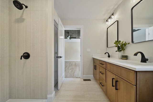 172 Tasker Hill Rd, Strafford, NH 03884 - bathroom featuring double vanity, tiled shower, and ceiling fan
