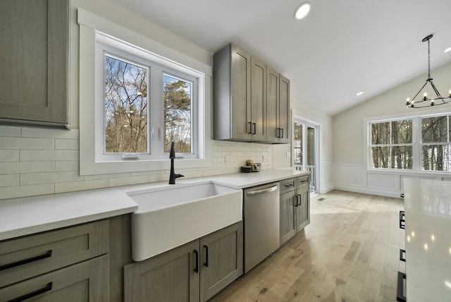 172 Tasker Hill Rd, Strafford, NH 03884 - kitchen featuring stainless steel dishwasher, decorative backsplash, light wood-style floors, healthy amount of natural light, and vaulted ceiling