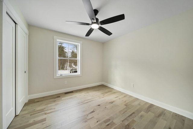 172 Tasker Hill Rd, Strafford, NH 03884 - unfurnished bedroom featuring light wood finished floors, a closet, and a ceiling fan