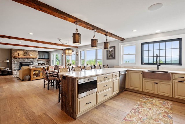 15 Glade Cir, Campton, NH 03223 - kitchen featuring cream cabinets, beamed ceiling, light countertops, light wood finished floors, and plenty of natural light