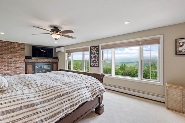 15 Glade Cir, Campton, NH 03223 - carpeted bedroom with a baseboard radiator, an AC wall unit, a glass covered fireplace, recessed lighting, and ceiling fan
