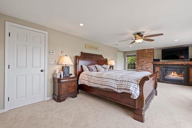 15 Glade Cir, Campton, NH 03223 - bedroom with light colored carpet, a glass covered fireplace, a ceiling fan, and recessed lighting