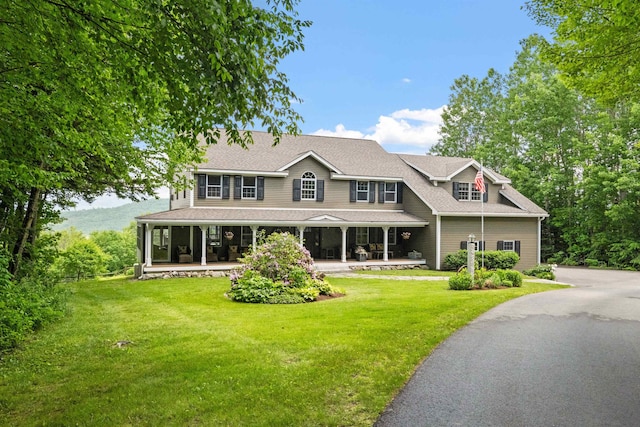 15 Glade Cir, Campton, NH 03223 - view of front of house with a front lawn, a porch, and roof with shingles