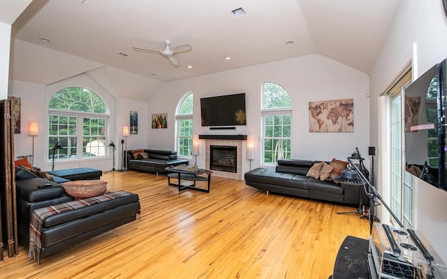 53 Lollypop Ln, Danville, NH 03819 - living area featuring lofted ceiling, hardwood / wood-style floors, ceiling fan, and a tiled fireplace