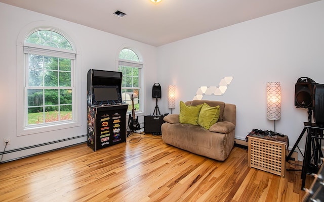 53 Lollypop Ln, Danville, NH 03819 - living area with light wood-style floors and a baseboard radiator