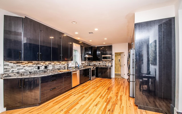 53 Lollypop Ln, Danville, NH 03819 - kitchen featuring stainless steel appliances, light wood-type flooring, decorative backsplash, modern cabinets, and recessed lighting