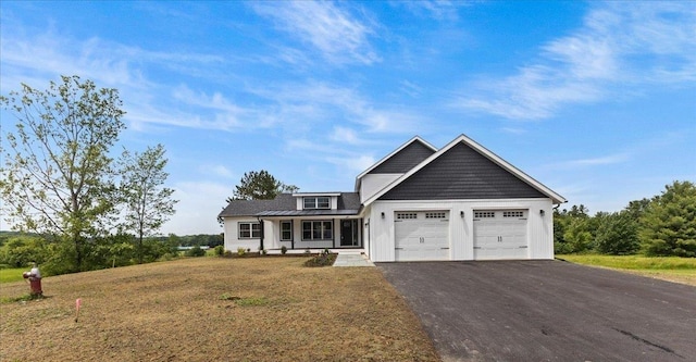 29 Taft St, Essex Junction, VT 05452 - view of front of property featuring a garage, asphalt driveway, and a front yard
