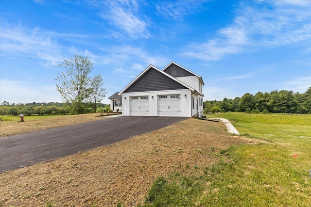 29 Taft St, Essex Junction, VT 05452 - view of side of property featuring driveway, an attached garage, and a yard