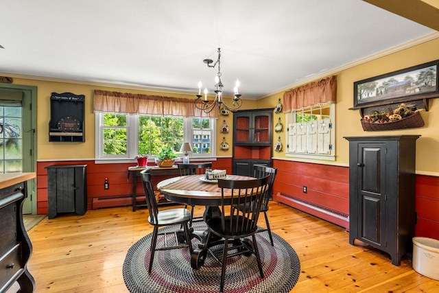 9 Jade Rd, Merrimack, NH 03054 - dining space featuring a baseboard heating unit, ornamental molding, plenty of natural light, light wood-style flooring, and a chandelier