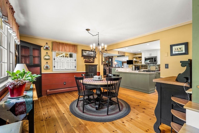 9 Jade Rd, Merrimack, NH 03054 - dining room with a baseboard radiator, crown molding, a chandelier, light wood finished floors, and recessed lighting