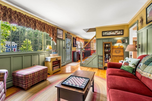 9 Jade Rd, Merrimack, NH 03054 - living area featuring light wood finished floors, plenty of natural light, stairs, a decorative wall, and ornamental molding