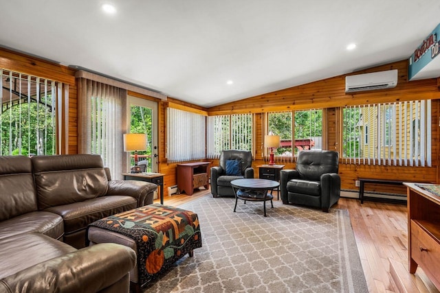 9 Jade Rd, Merrimack, NH 03054 - living room featuring vaulted ceiling, a wall mounted air conditioner, hardwood / wood-style floors, plenty of natural light, and wood walls