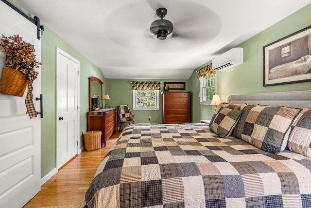 9 Jade Rd, Merrimack, NH 03054 - bedroom featuring a wall mounted AC, wood finished floors, and a ceiling fan
