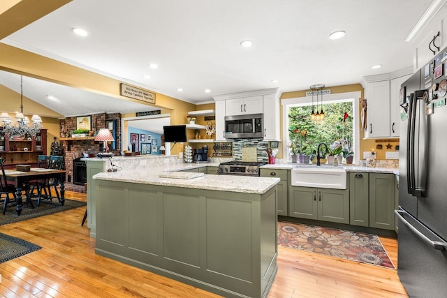 9 Jade Rd, Merrimack, NH 03054 - kitchen with freestanding refrigerator, stainless steel microwave, green cabinetry, stove, and light wood-type flooring