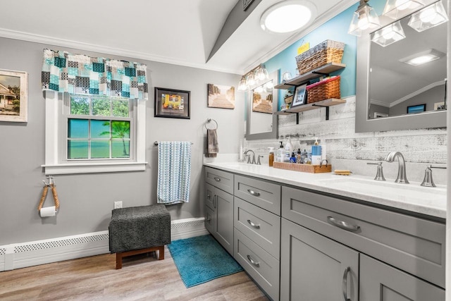 9 Jade Rd, Merrimack, NH 03054 - bathroom with crown molding, double vanity, tasteful backsplash, wood finished floors, and a baseboard heating unit