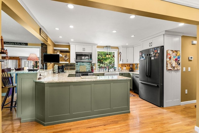 9 Jade Rd, Merrimack, NH 03054 - kitchen featuring freestanding refrigerator, stainless steel microwave, white cabinets, light wood-type flooring, and recessed lighting