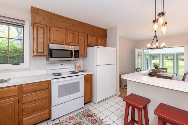 5 Golf Vw Unit B, Laconia, NH 03246 - kitchen featuring white appliances, light countertops, and a breakfast bar area