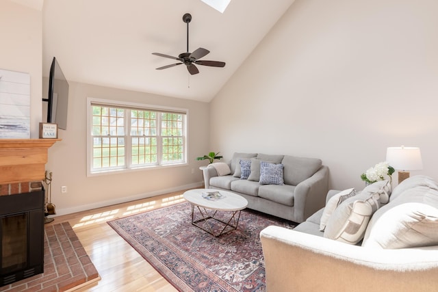 5 Golf Vw Unit B, Laconia, NH 03246 - living room with a fireplace, wood finished floors, high vaulted ceiling, a ceiling fan, and a skylight