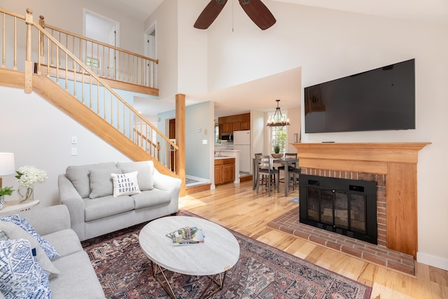 5 Golf Vw Unit B, Laconia, NH 03246 - living room with light wood finished floors, stairs, ceiling fan, a fireplace, and a chandelier