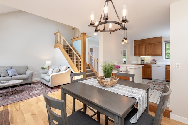5 Golf Vw Unit B, Laconia, NH 03246 - dining space featuring stairs, a chandelier, and light wood-style floors