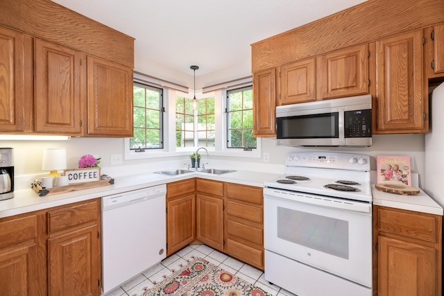 5 Golf Vw Unit B, Laconia, NH 03246 - kitchen featuring white appliances, light tile patterned floors, light countertops, decorative light fixtures, and brown cabinets