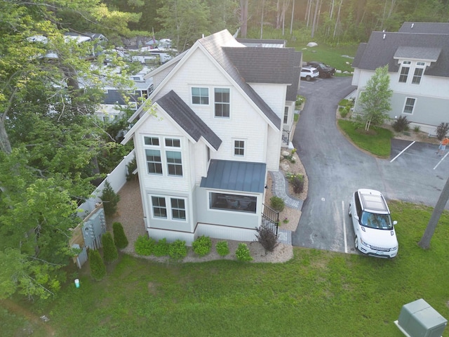109 Weirs Blvd Unit 9, Laconia, NH 03246 - back of property featuring a standing seam roof, a yard, a metal roof, and a shingled roof