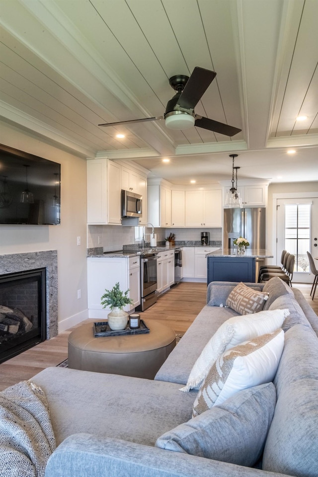 109 Weirs Blvd Unit 9, Laconia, NH 03246 - living area featuring light wood-style flooring, ceiling fan, crown molding, a fireplace, and recessed lighting