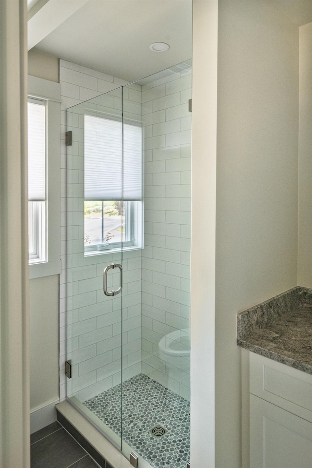 109 Weirs Blvd Unit 9, Laconia, NH 03246 - full bath with plenty of natural light, a stall shower, vanity, and tile patterned floors
