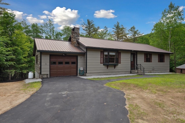 13 Seyah Rd, Shelburne, NH 03581 - ranch-style home with an attached garage, a chimney, driveway, and a metal roof