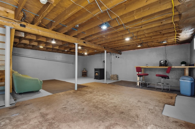 13 Seyah Rd, Shelburne, NH 03581 - unfinished basement with a wood stove, carpet, and stairway