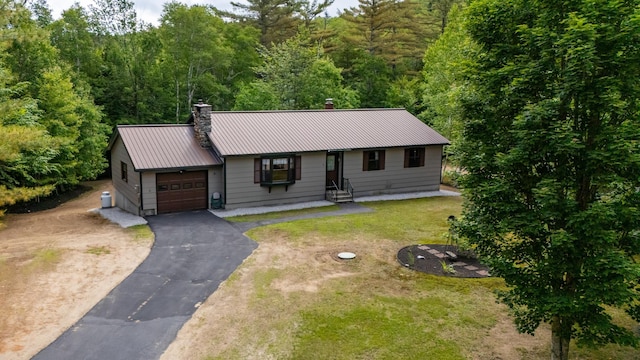 13 Seyah Rd, Shelburne, NH 03581 - ranch-style house featuring a chimney, a garage, asphalt driveway, a metal roof, and a front yard