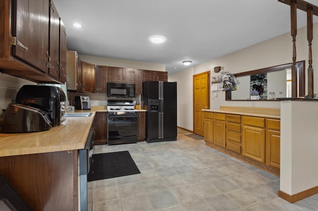13 Seyah Rd, Shelburne, NH 03581 - kitchen with black appliances, wooden counters, and dark brown cabinetry