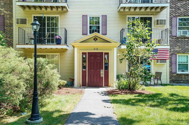 2 Autumn Leaf Dr Unit 20, Nashua, NH 03060 - view of exterior entry featuring a balcony and a yard