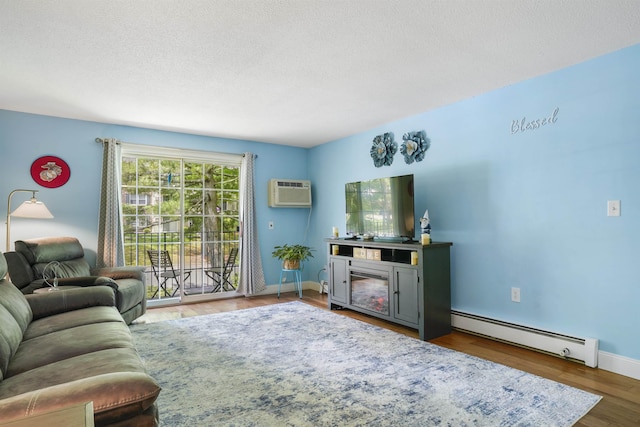 2 Autumn Leaf Dr Unit 20, Nashua, NH 03060 - living room with a baseboard heating unit, an AC wall unit, wood finished floors, a fireplace, and a textured ceiling