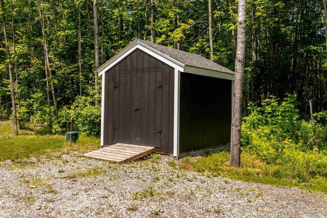 65 Glidden Rd, Croydon, NH 03773 - view of shed featuring a wooded view