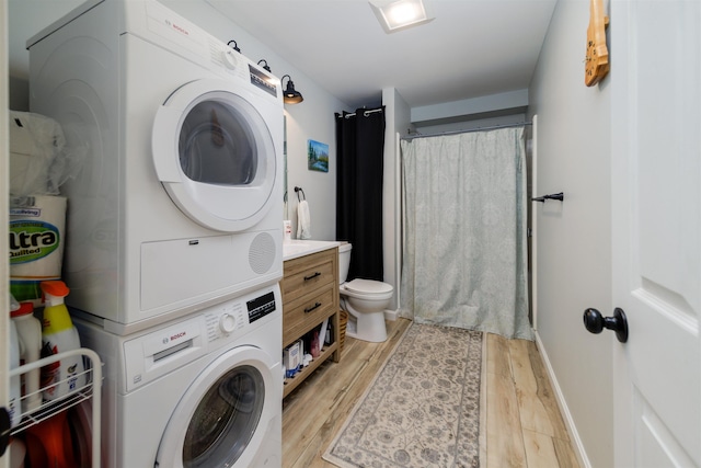 65 Glidden Rd, Croydon, NH 03773 - laundry area with stacked washing machine and dryer and light wood-type flooring