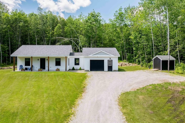 65 Glidden Rd, Croydon, NH 03773 - view of front of home featuring a storage shed, a garage, a porch, dirt driveway, and a front lawn