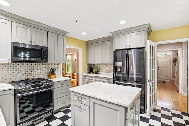 27 Olde Common Dr, Atkinson, NH 03811 - kitchen with stainless steel appliances, light floors, gray cabinets, tasteful backsplash, and recessed lighting