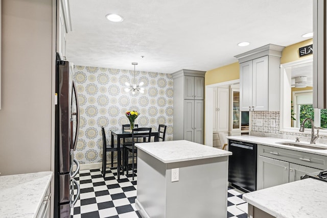27 Olde Common Dr, Atkinson, NH 03811 - kitchen featuring dark flooring, freestanding refrigerator, gray cabinetry, wallpapered walls, and a chandelier