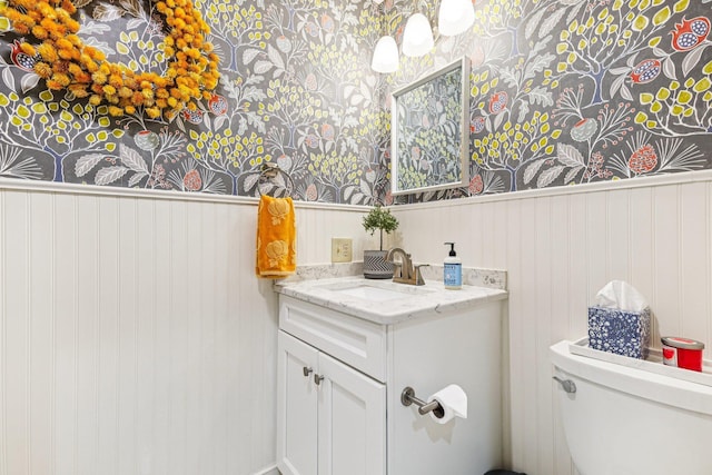 27 Olde Common Dr, Atkinson, NH 03811 - half bathroom with vanity, a wainscoted wall, and wallpapered walls